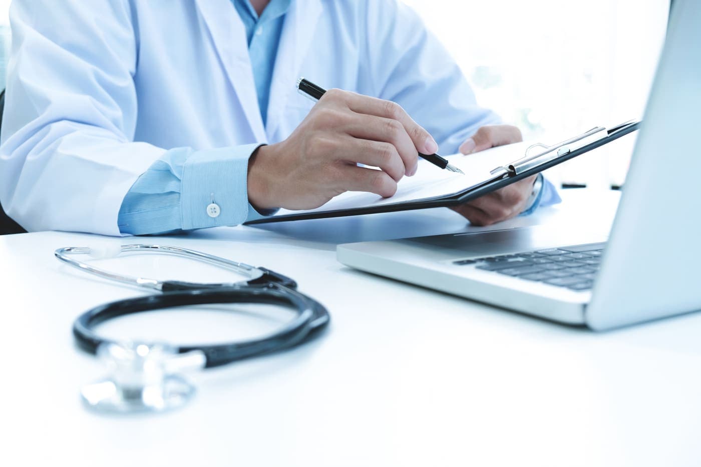 Medical billing specialist reviewing claims and reimbursement paperwork